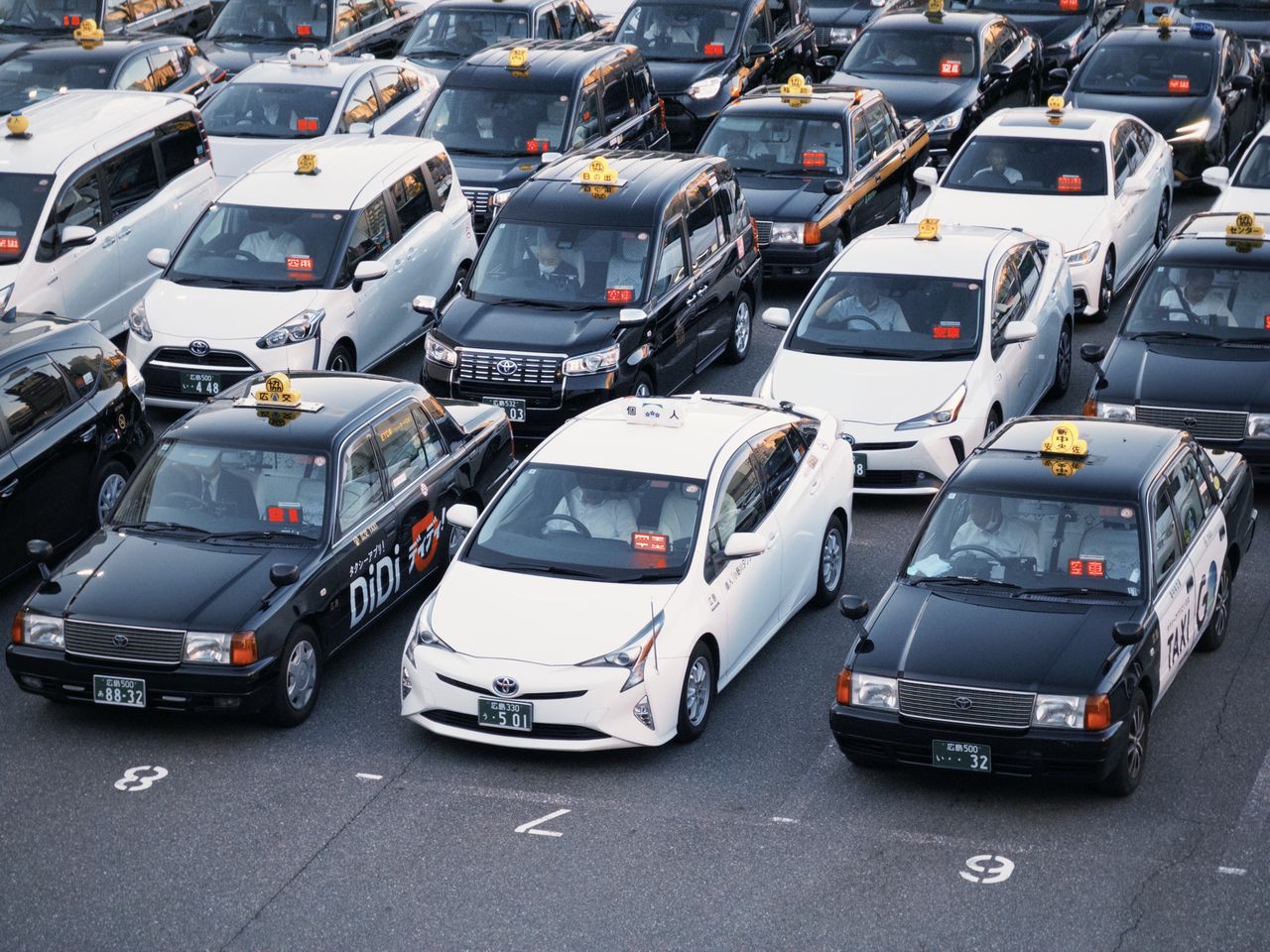 The Art of Drawing Readers In: Your attractive post title goes here Taxis lined up in a parking lot, showcasing urban transportation in Japan.